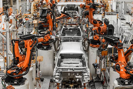 A view of several cars on an assembly line